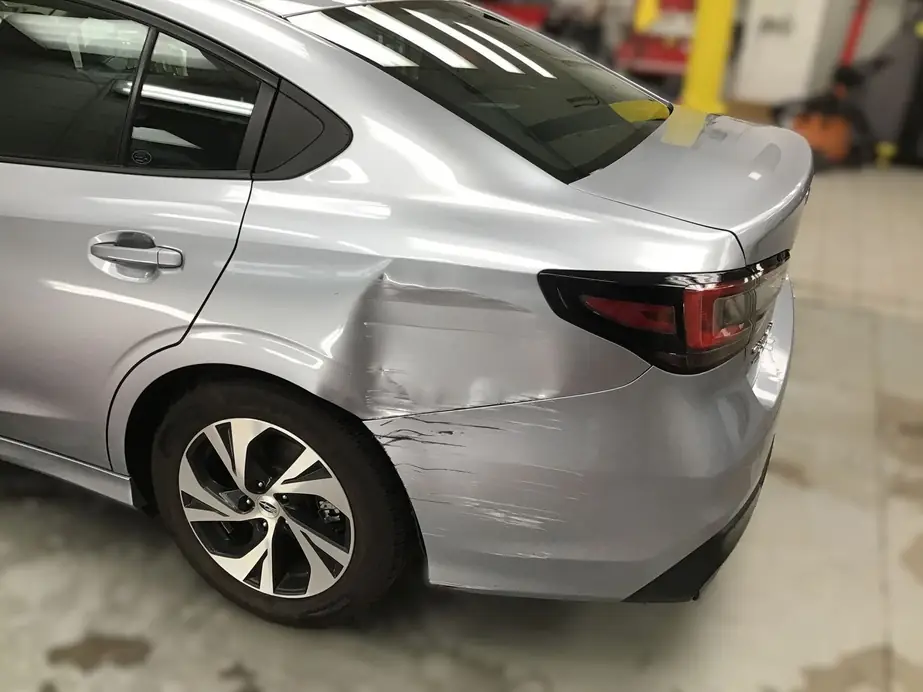 Subaru Legacy with rear bumper and quarter panel damage, before repair